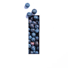 Letter I of English alphabet made of blueberries and paper cut isolated on white. Ecofriendly blue berries typeface