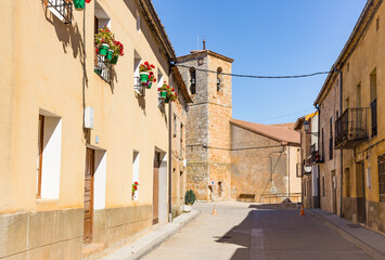 a street in Alcubilla de Avellaneda town with a view to the church, province of Soria, Castile and Leon, Spain