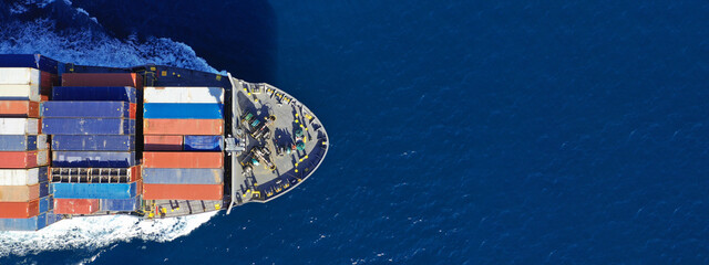 Aerial drone ultra wide photo of colourful truck size container tanker ship cruising deep blue sea...