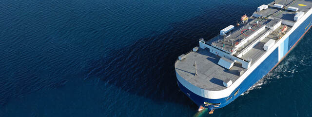 Aerial drone ultra wide photo of huge car carrier ship RO-RO (Roll on Roll off) cruising in...