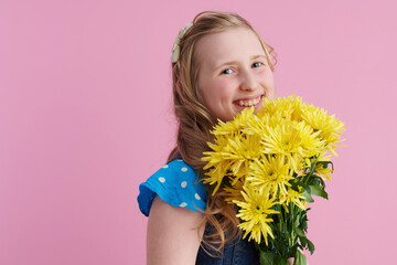 Portrait of happy modern girl with long wavy blond hair on pink