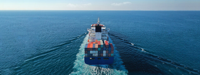 Aerial drone ultra wide photo of colourful truck size container tanker ship cruising deep blue sea...