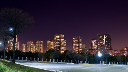 Illuminated, tall buildings at night time.