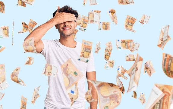 Young hispanic man wearing casual clothes smiling and laughing with hand on face covering eyes for surprise. blind concept.