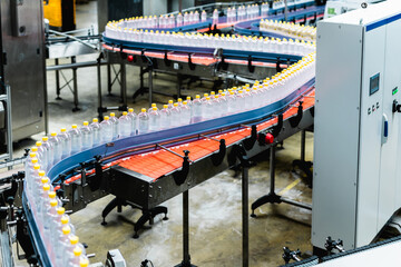 Bottling factory - Juice bottling line for processing and bottling lemon juice into bottles. Selective focus.