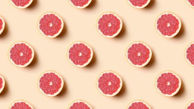 Slow motion of seamless pattern of grapefruit half slice. Food 4k video.