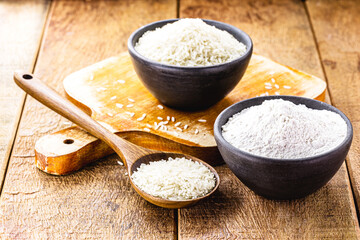 fine and ground rice flour, in handmade clay pot with rustic wooden spoon