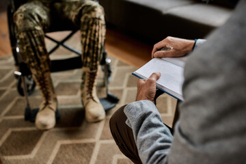 Selective focus on notebook in psychotherapist hands