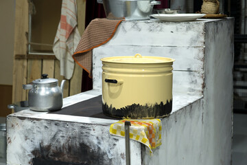 mock-up of a Russian oven with a large pot and an aluminum kettle