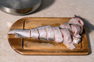 raw pieces of fish on a wooden board