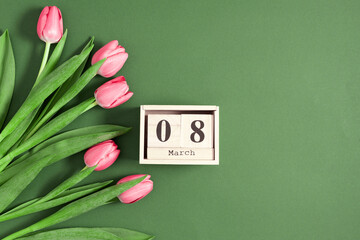 Beautiful pink tulips and calendar on pastel green background. Concept Women's Day, March 8. 8th...