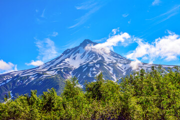 mountain landscape with blue sky and green forest. Kamchatka Russia