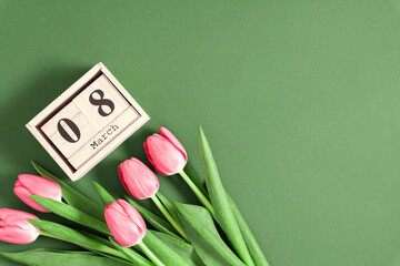 Beautiful pink tulips and calendar on pastel green background. Concept Women's Day, March 8. 8th...
