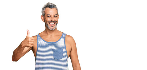 Middle age grey-haired man wearing casual style with sleeveless shirt smiling happy and positive,...