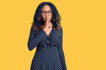 Young african american woman wearing casual clothes and glasses asking to be quiet with finger on...