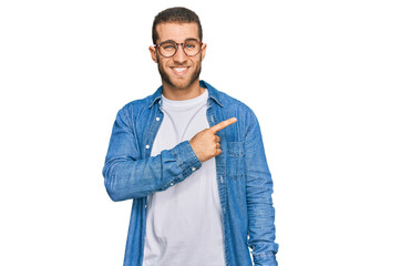 Fototapeta premium Young caucasian man wearing casual clothes pointing aside worried and nervous with forefinger, concerned and surprised expression