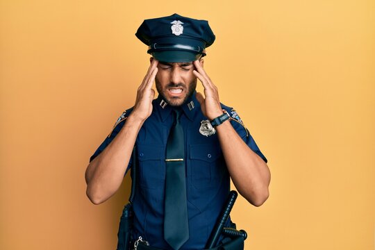 Handsome hispanic man wearing police uniform with hand on head, headache because stress. suffering migraine.