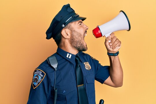 American police officer shouting through megaphone, yelling and protesting