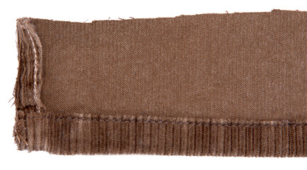 Lining of brown cotton corduroy retail, showing hem, against white background