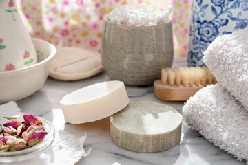 Fototapeta na wymiar Spotlight on ecological homemade soaps and solid shampoo in the bathroom