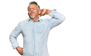 Middle age grey-haired man wearing casual clothes suffering of neck ache injury, touching neck with hand, muscular pain