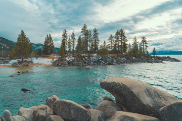 Snow covered mountains and trees by the lake in South Lake Tahoe, Nevada