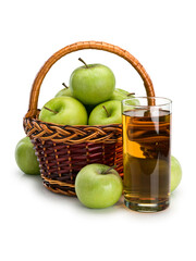 Glass with apple juice and basket with fruits of green apples