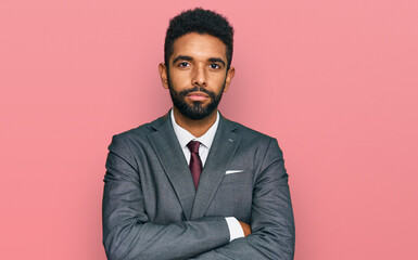 Young african american man wearing business clothes skeptic and nervous, disapproving expression on...