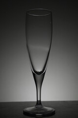 empty champagne glass in dark back lit