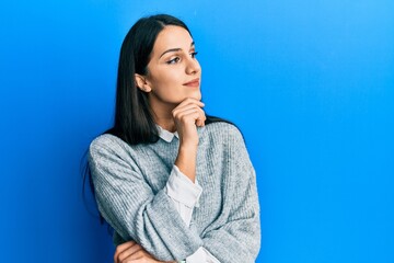 Young hispanic woman wearing casual clothes with hand on chin thinking about question, pensive expression. smiling with thoughtful face. doubt concept.