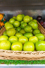 Fresh lemon lime on the shelves in the supermarket for customers, citrus pattern
