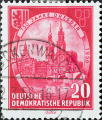 GERMANY, DDR - CIRCA 1956  : a postage stamp from Germany, GDR showing a drawing of Georgentor, Augustus Bridge, Hausmannsturm, Catholic Court Church in Dresden. With coat of arms