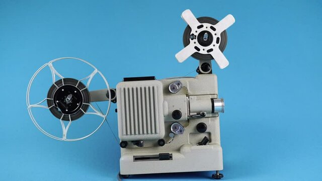 Retro Movie Projector Work On A Blue Background. 
