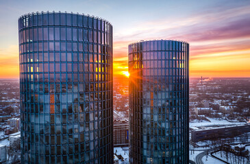 Riga city panorama at colorful sunset in blue hour. Modern skyscrapers next to picturesque view...