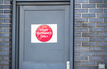 Staff entrance sign on private door at school