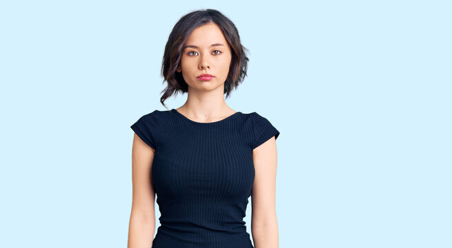 Young beautiful girl wearing casual clothes with serious expression on face. simple and natural looking at the camera.