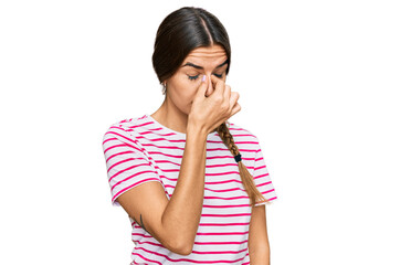 Young hispanic woman wearing casual clothes tired rubbing nose and eyes feeling fatigue and headache. stress and frustration concept.