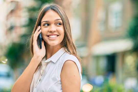 Beautiful latin teenager girl smiling happy talking on the smartphone at the city.