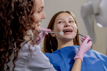 Professional doctor dentist examine and treat spoiled teeth with the use of special dental instruments, medical equipments. Healthy teeth concept.