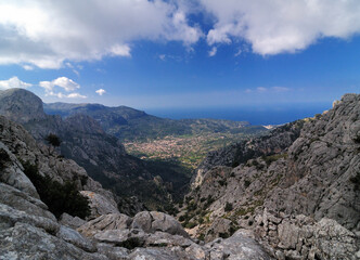Fototapeta na wymiar Spectacular View From The Summit Of Mount L'Ofre To The Village Of Soller In The Tramuntana Mountains On Balearic Island Mallorca On A Sunny Winter Day With A Few Clouds In The Blue Sky