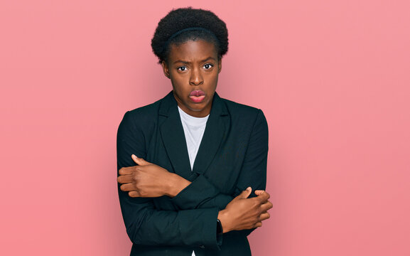Young african american girl wearing business clothes shaking and freezing for winter cold with sad and shock expression on face