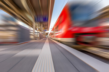 Obraz na płótnie Canvas Fast moving train at station. Motion blur