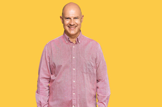 Middle age bald man wearing casual clothes with a happy and cool smile on face. lucky person.