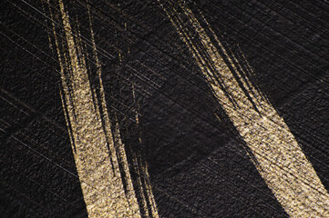 Black and gold textured background, gold lines on a black background. Hand drawing, abstract painting.  