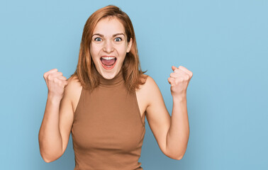 Young caucasian woman wearing casual clothes celebrating surprised and amazed for success with arms raised and open eyes. winner concept.