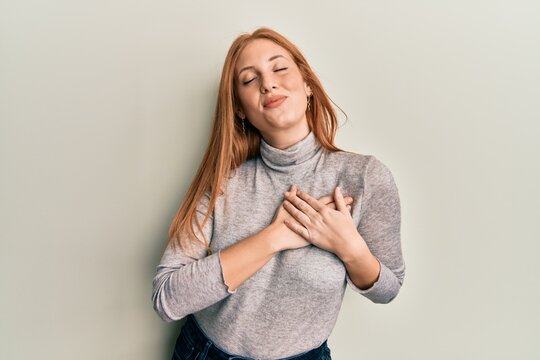 Young irish woman wearing casual clothes smiling with hands on chest, eyes closed with grateful gesture on face. health concept.
