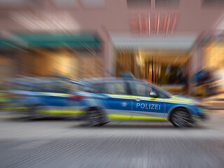 Motion blur of German police car with letters POLIZEI.
