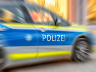 Motion blur of German police car with letters POLIZEI.