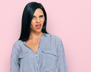 Young caucasian woman wearing casual clothes in shock face, looking skeptical and sarcastic, surprised with open mouth