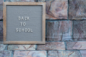 Back to school poster embedded on grey background